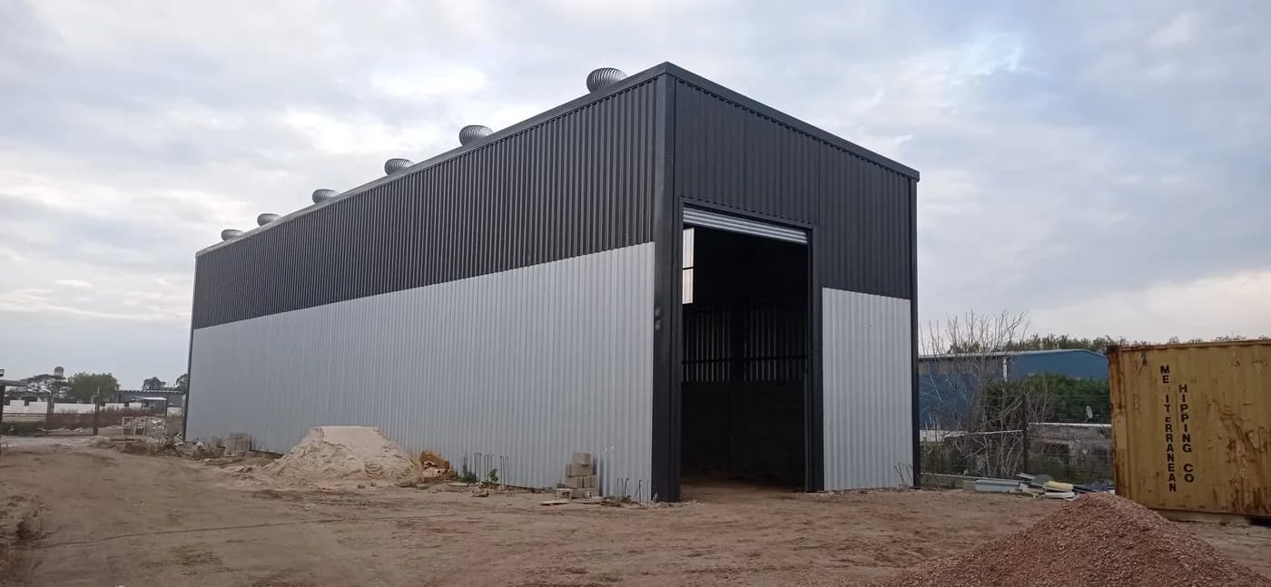 Galpón industrial metálico negro y gris construido por MF Construcciones Uruguay